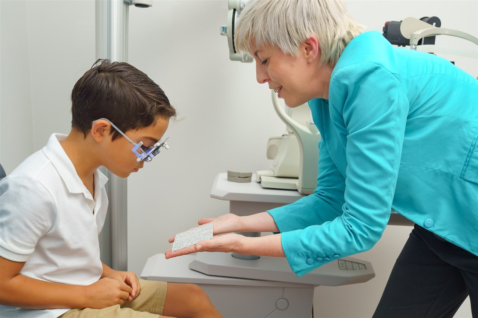 Kindvriendelijke optometrist voert een oogtest uit bij een kind in Amsterdam.